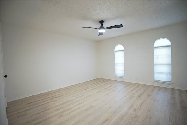 spare room featuring ceiling fan, a textured ceiling, and light wood-type flooring