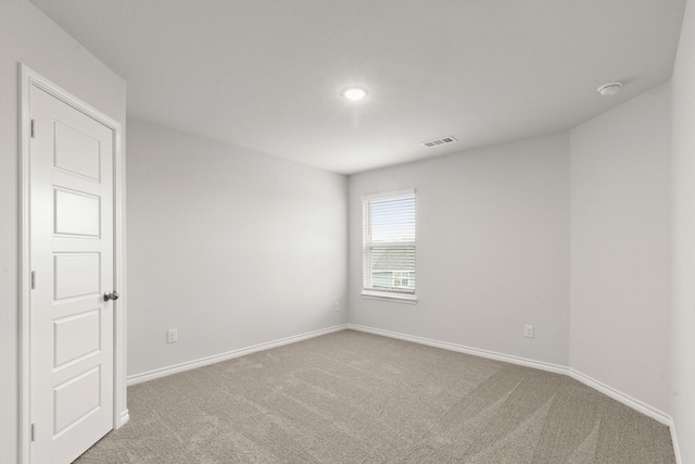 empty room featuring light carpet