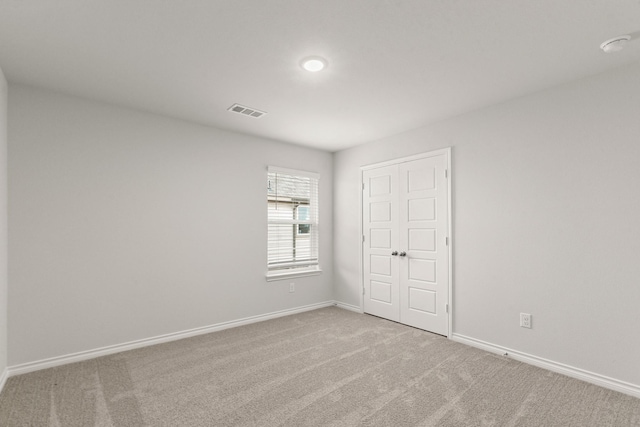 empty room with light colored carpet