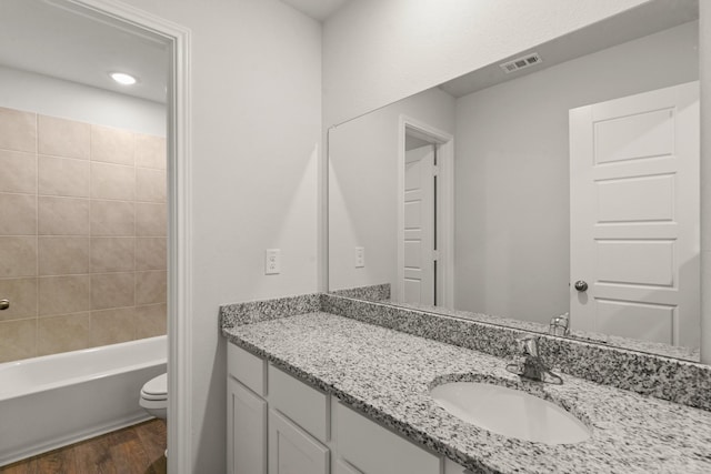 bathroom featuring vanity, hardwood / wood-style flooring, and toilet