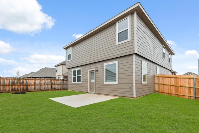 rear view of house with a patio and a lawn