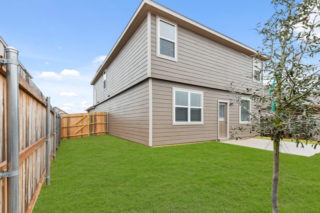 rear view of property featuring a yard