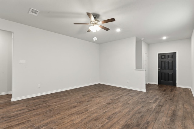 empty room with ceiling fan and dark hardwood / wood-style floors