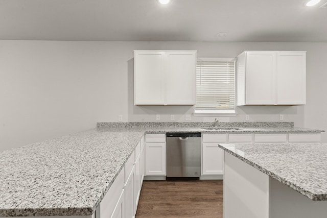 kitchen with sink, light stone countertops, white cabinets, dark hardwood / wood-style flooring, and stainless steel dishwasher