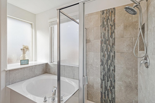 bathroom featuring separate shower and tub