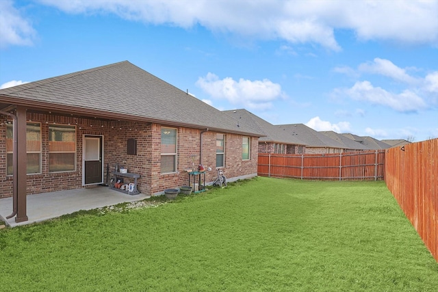 rear view of house featuring a patio area and a lawn