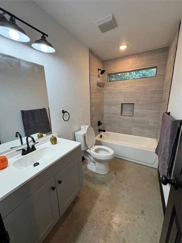 full bathroom featuring concrete flooring, vanity, toilet, and tiled shower / bath