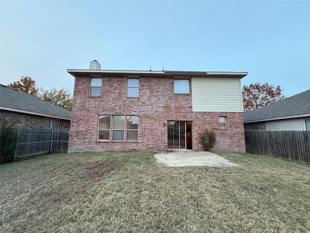 rear view of property with a patio area and a yard