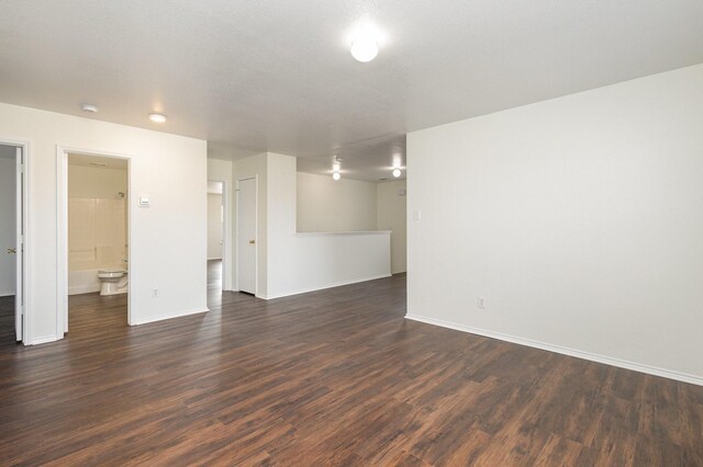 corridor with dark wood-type flooring