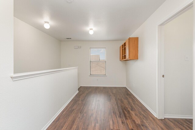 hall with a textured ceiling, dark hardwood / wood-style floors, and sink