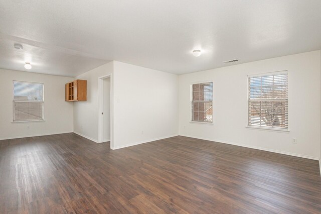 unfurnished room featuring dark hardwood / wood-style floors and a textured ceiling