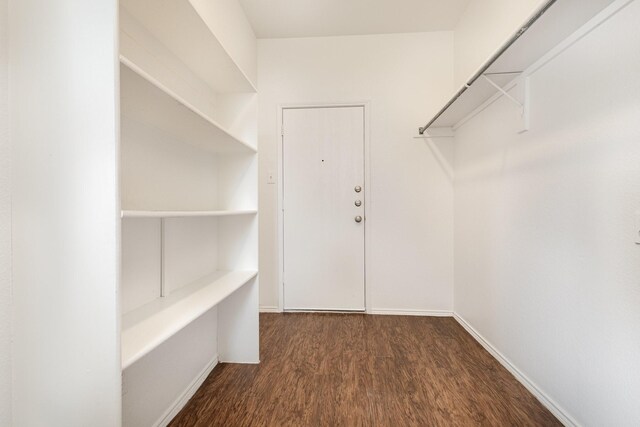 bathroom featuring a washtub, a textured ceiling, vanity, hardwood / wood-style flooring, and toilet