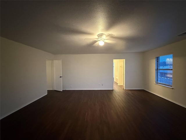 unfurnished room featuring a textured ceiling, ceiling fan, and dark wood-type flooring