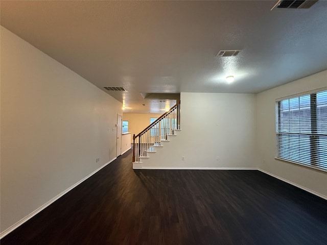 basement with dark hardwood / wood-style flooring and a textured ceiling