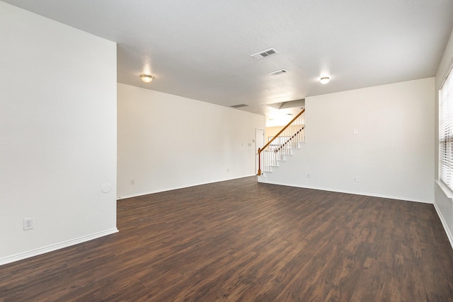 empty room with dark hardwood / wood-style flooring