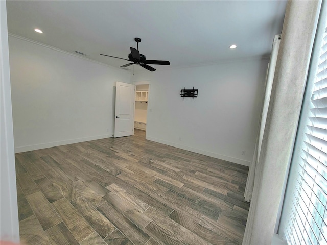 spare room with ceiling fan, dark hardwood / wood-style flooring, and ornamental molding