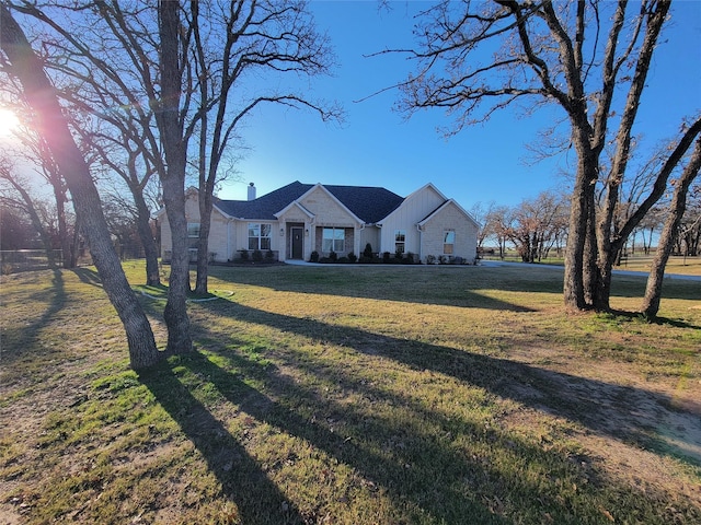 view of front of home featuring a front yard and a chimney