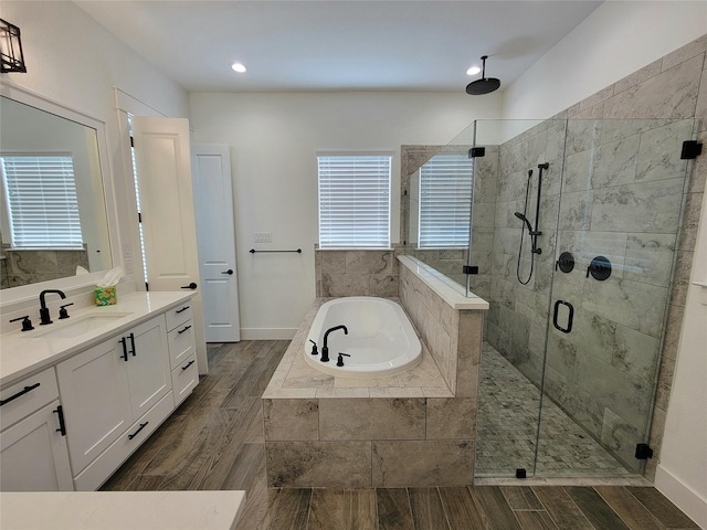 bathroom featuring vanity and shower with separate bathtub