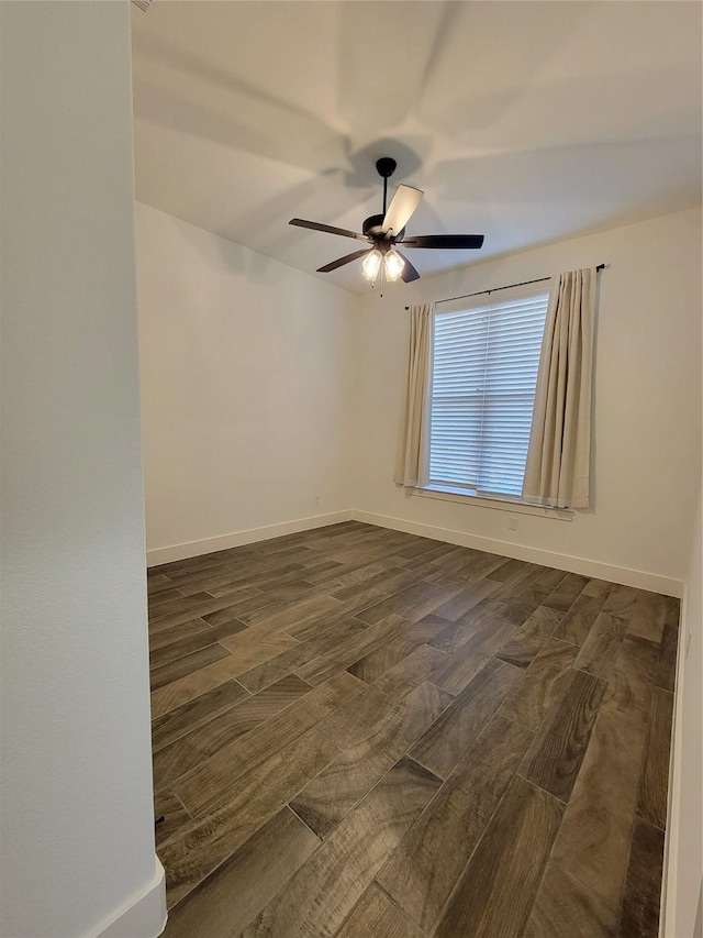 empty room with ceiling fan and dark wood-type flooring