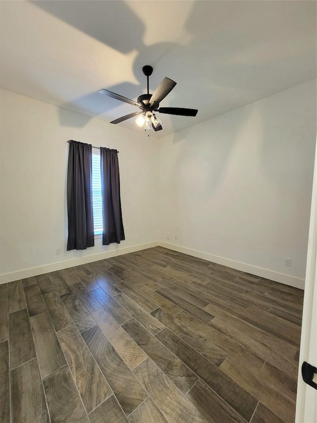 spare room with ceiling fan and dark hardwood / wood-style floors