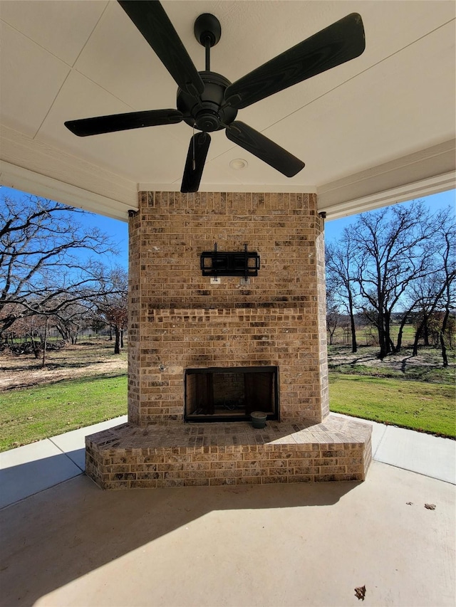 view of patio featuring ceiling fan and an outdoor brick fireplace