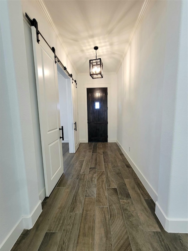 entryway with a barn door and crown molding