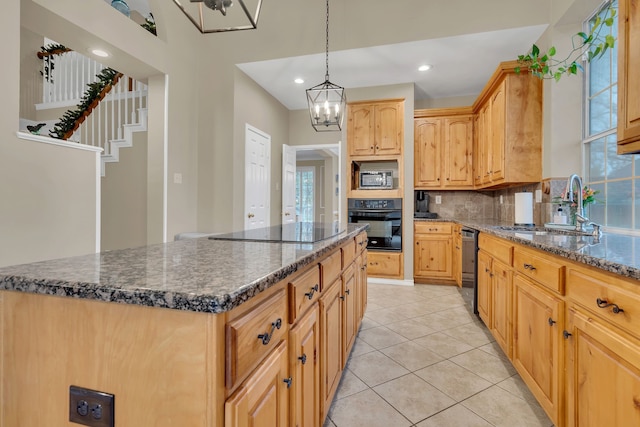 kitchen with a center island, sink, a chandelier, light tile patterned floors, and black appliances