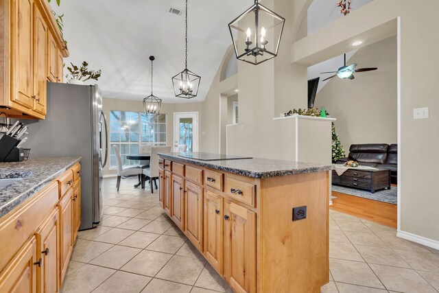 kitchen featuring pendant lighting, a kitchen island, ceiling fan, and light tile patterned flooring