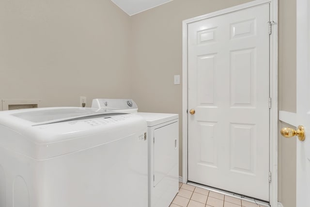 laundry room with light tile patterned floors and separate washer and dryer