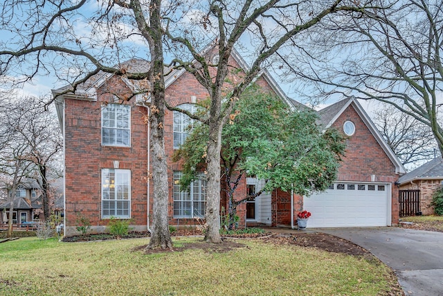 view of front property featuring a garage and a front lawn