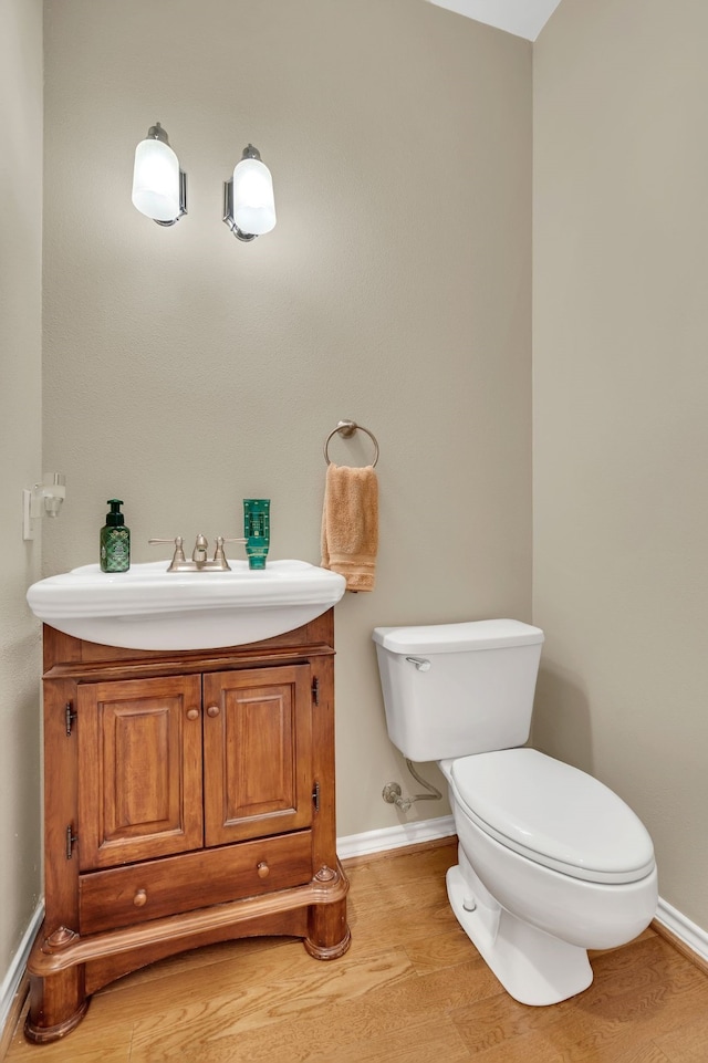 bathroom featuring hardwood / wood-style flooring, vanity, and toilet