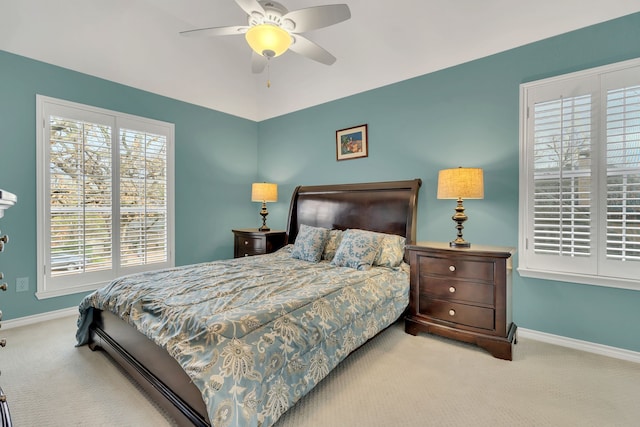 bedroom featuring ceiling fan and light carpet