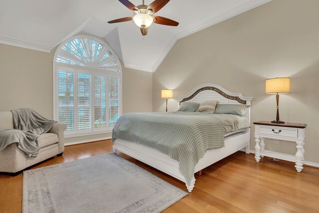 bedroom featuring ceiling fan, ornamental molding, vaulted ceiling, and hardwood / wood-style flooring