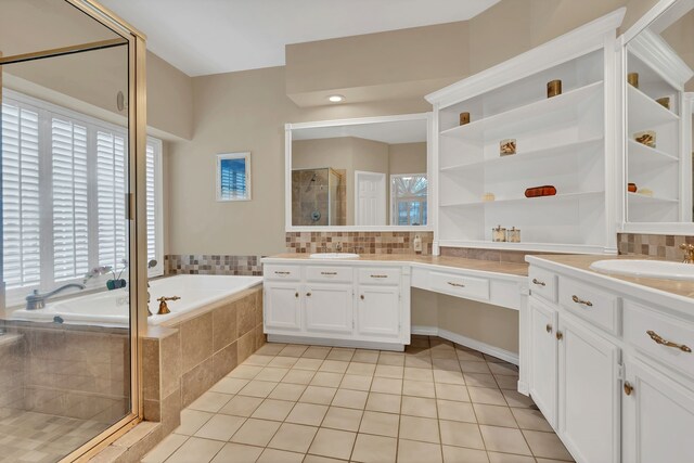 bathroom featuring tile patterned flooring, vanity, shower with separate bathtub, and tasteful backsplash