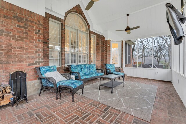 sunroom / solarium with ceiling fan and vaulted ceiling