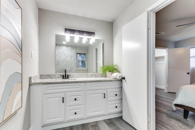 bathroom with hardwood / wood-style flooring, vanity, and ceiling fan