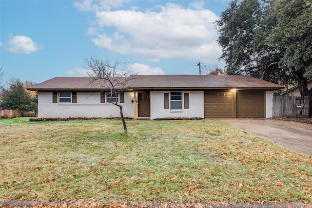 ranch-style house featuring a front yard and a garage