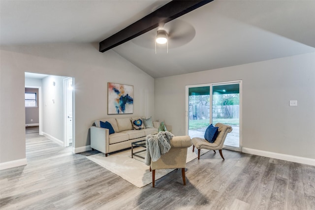 living room with vaulted ceiling with beams, light hardwood / wood-style flooring, and ceiling fan