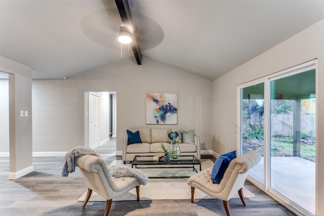 living room with hardwood / wood-style floors, ceiling fan, and lofted ceiling with beams