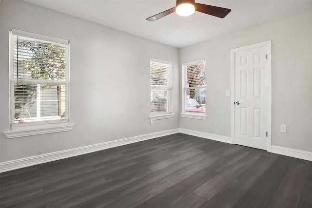 empty room with ceiling fan and dark hardwood / wood-style flooring