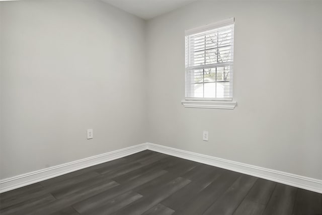 unfurnished room featuring dark wood-type flooring