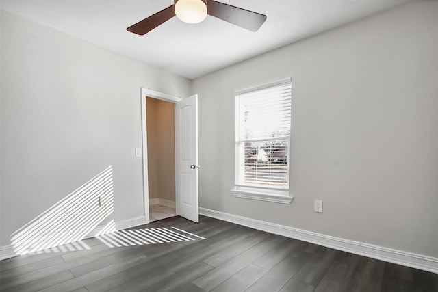 empty room featuring ceiling fan and dark hardwood / wood-style floors