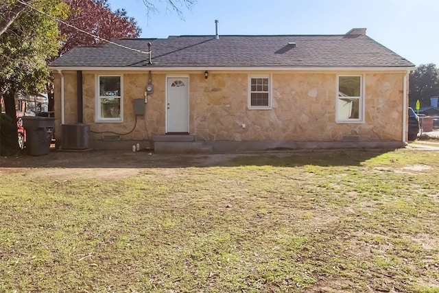 view of front of property featuring central AC and a front yard