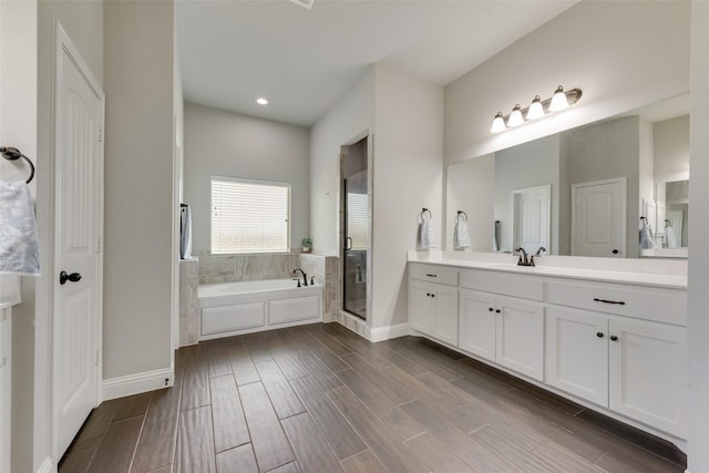 bathroom featuring plus walk in shower and vanity