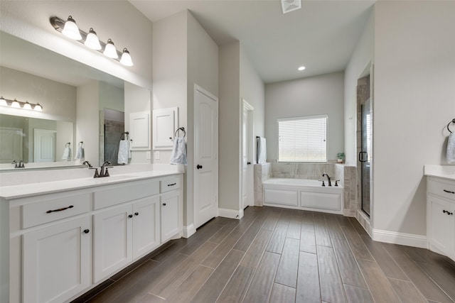 bathroom featuring vanity and plus walk in shower