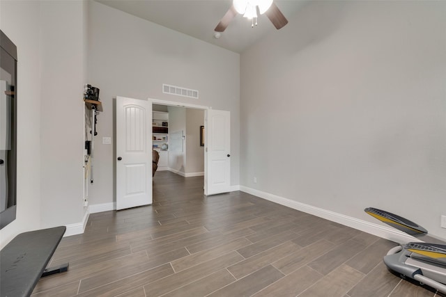 interior space with a high ceiling and ceiling fan