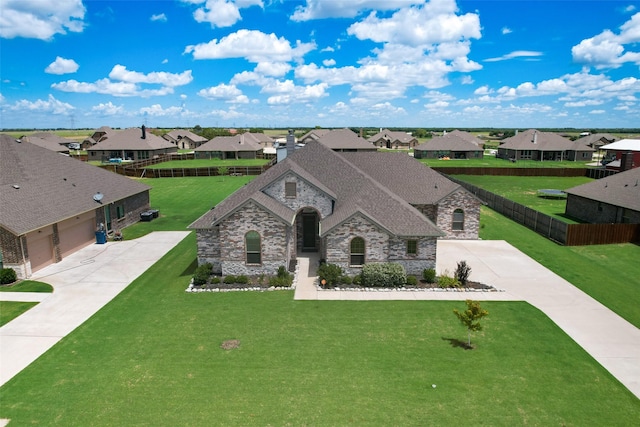 view of front of property with a garage and a front lawn