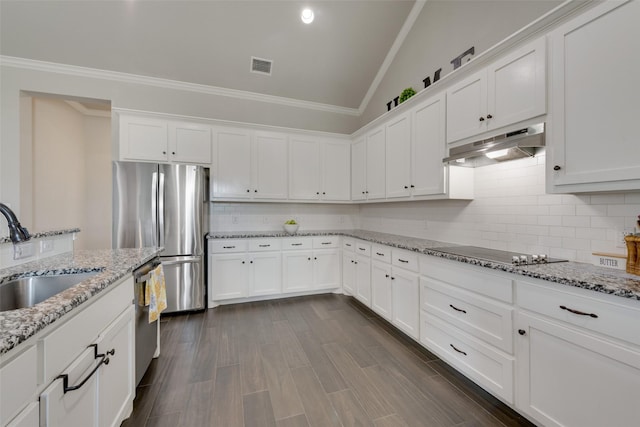 kitchen with sink, white cabinets, vaulted ceiling, and appliances with stainless steel finishes