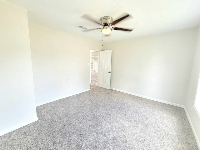 empty room featuring ceiling fan and carpet floors