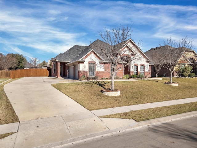 view of front of home featuring a front yard and a garage